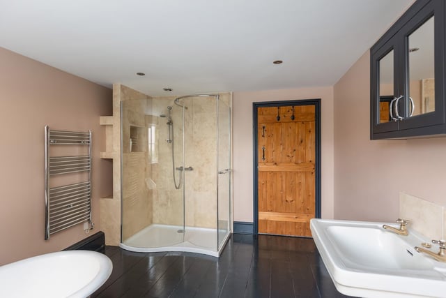 A free standing bath and a walk-in shower cubicle feature within this modern bathroom.