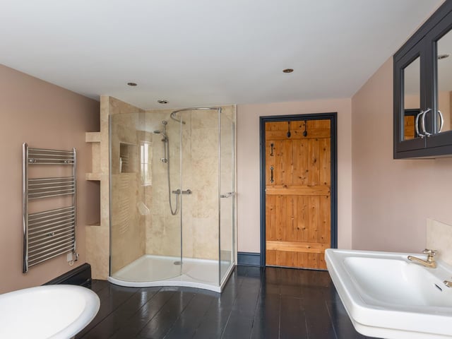 A free standing bath and a walk-in shower cubicle feature within this modern bathroom.