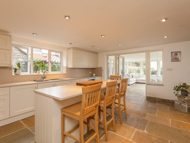The bright and spacious kitchen that leads through to the orangery.