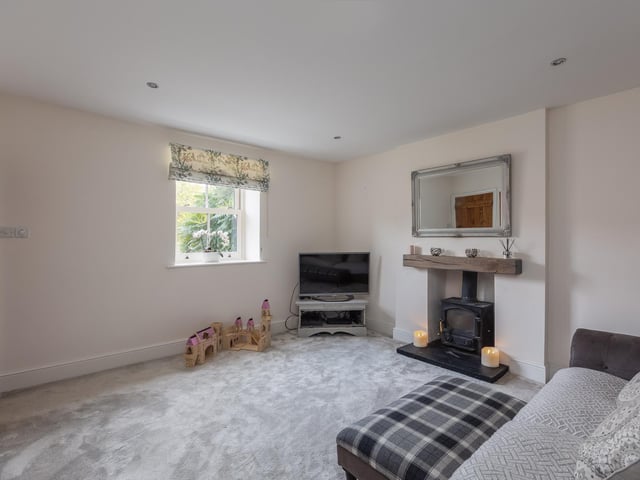 There's a feature fireplace within this room, with spotlights to the ceiling.