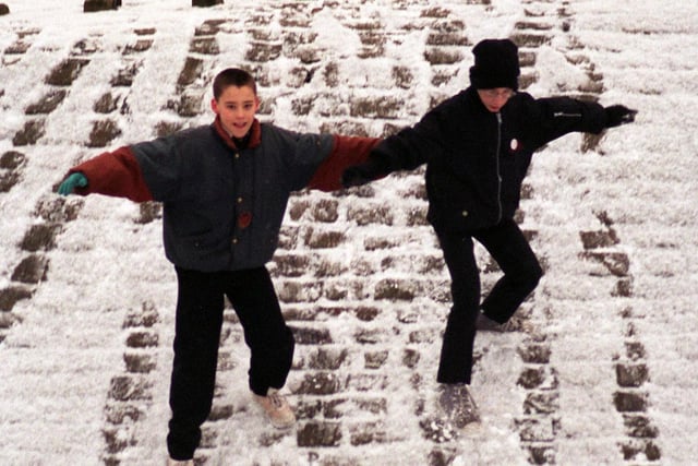 Andrew Robinson (right) and Antony Coates took advantage of snowfall at Cross Flatts Park in January 1996 for a little fun on the way to school.