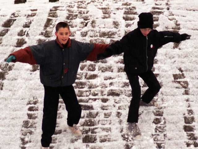 Andrew Robinson (right) and Antony Coates took advantage of snowfall at Cross Flatts Park in January 1996 for a little fun on the way to school.