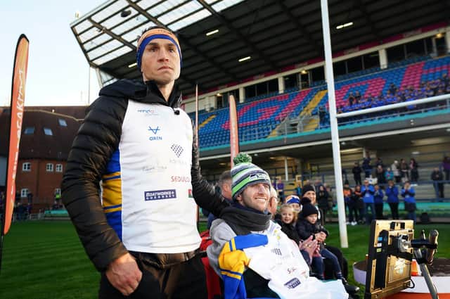 FINISH LINE: Kevin Sinfield stands with Rob Burrow after completing his Extra Mile challenge. Picture: PA Wire.