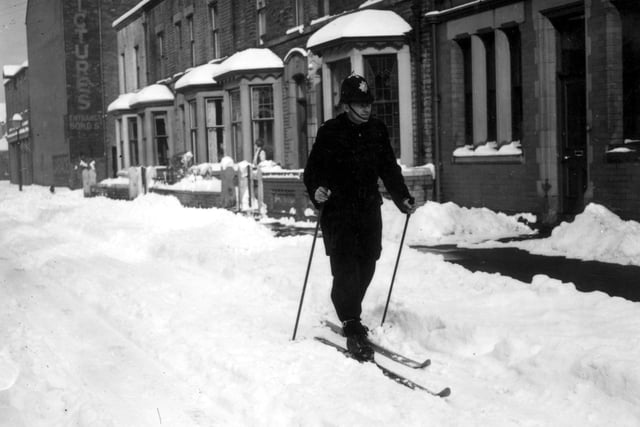 A policeman skis through the streets during a heavy snowfall in the 1980s
