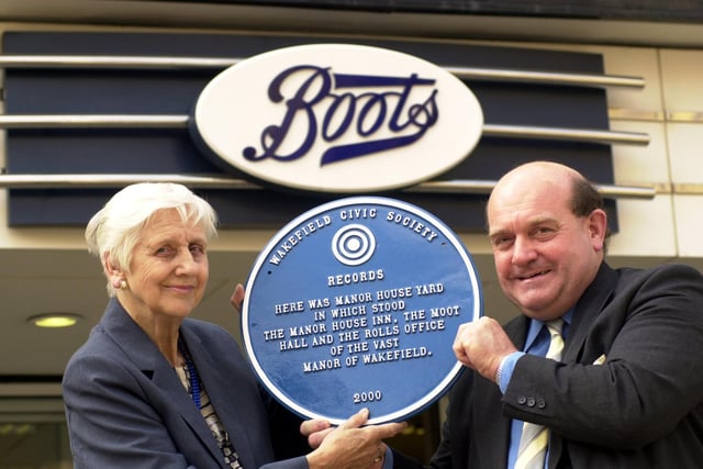 Members of the Wakefield Civic Society receiving a blue plaque to commemorate the Moot Hall. The plaque was be put onto the wall of the Boots store in the city centre . Pictured is Civic Society president Jean Coppack and Boots manager Peter Walker.