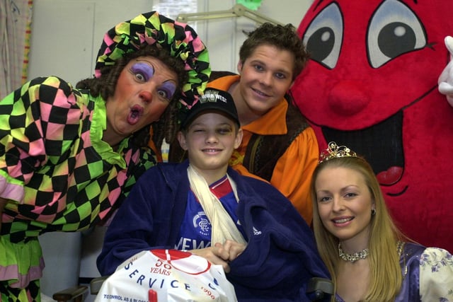 Stars from the cast of Wakefield Theatre's 'Jack and the Beanstalk' joined National Blood Service mascot Billy the Blood Drop on a visit to children's ward at Pinderfields. Pictured are Dame Trott (Phil Haze), Princess Marigold (Sarah Beaumont) Jack (Roman Marek) and young patient Adam Heartley.