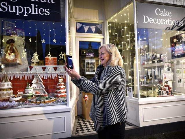 Jo Pickard takes a picture outside The Icing Store
