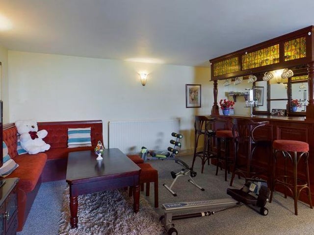 The built-in bar with seating and tables is a notable feature.