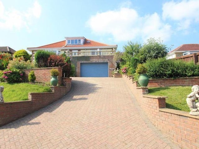 The driveway up to the villa style home in its elevated position.
