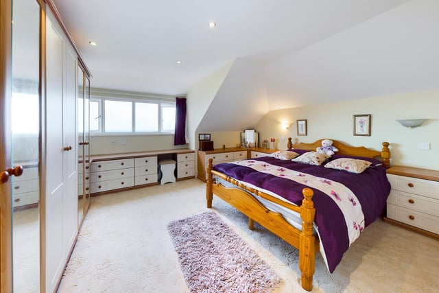One of the spacious bedrooms within the property.