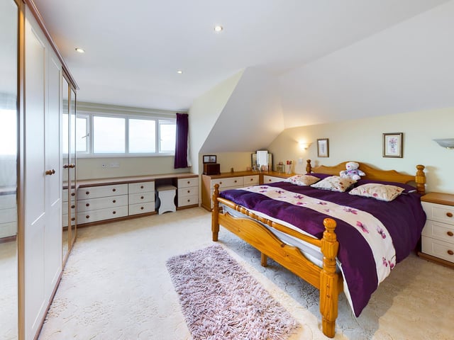 One of the spacious bedrooms within the property.