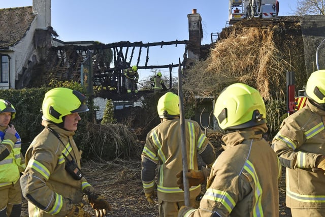 Firefighters examine the damage