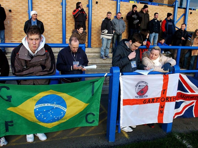 English and Brazilian flags are placed on the terraces at Garforth Town ahead of his debut for the non-league side.