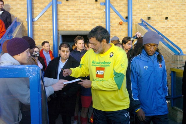 Socrates signs autographs for fans ahead of kick-off.