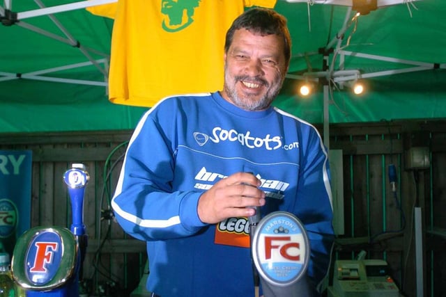 Socrates pulls a pint behind the clubhouse bar after the game.