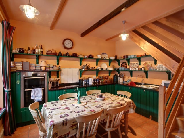 The dining kitchen has a fitted window seat and its facilities include integral appliances.