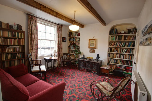 This sitting room has alcove features, that are currently lined with bookshelves.