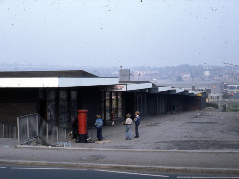 A parade of shops on Meanwood Street, off Oatland Lane, Leeds, including a post office and newsagents with a postbox outside. The shops have since been demolished.