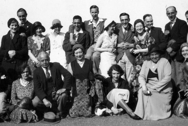 A large group of former Leeds library staff on an outing to Scarborough circa 1920s. Pictured, from left on the back row are, Sidney Thompson, Bessie .........., Mrs Bateson, Harvey Bateson, Teddy Hargreaves, Lily ........, Mrs (?), Grace ........., (?). Front row: Roland Smith, Mrs Price, Mr Strother, Hilda Padgett, Ella ........, Hum...(?), Phyllis Daft.