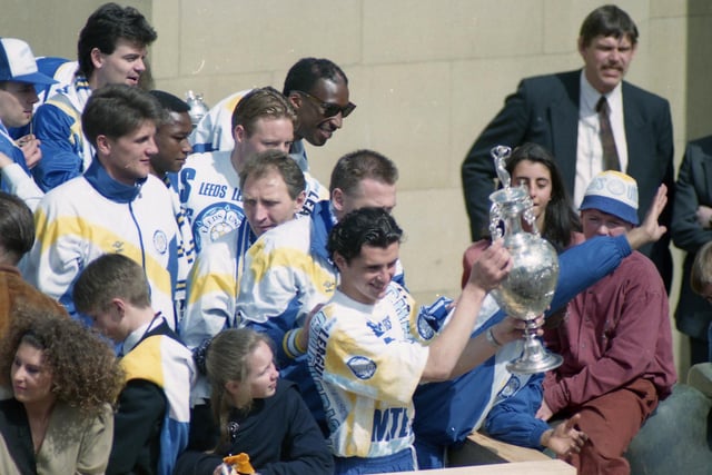 Speed holds the Championship trophy aloft as the Whites celebrate the Division One title at Leeds art gallery.