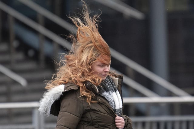 Lady braves the windy conditions in Leeds centre as Storm Arwen