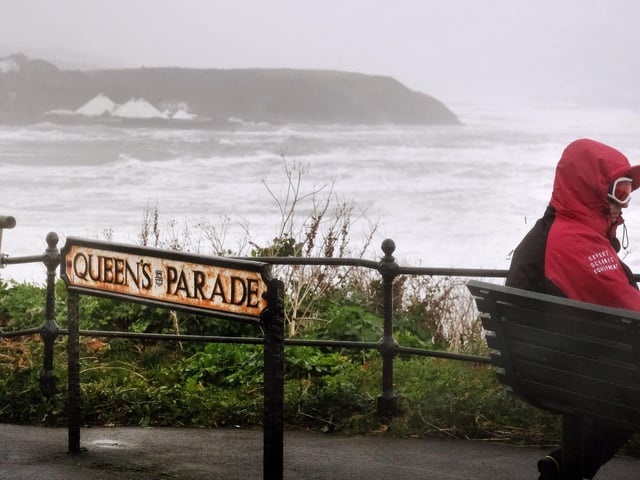 Kitted out to view the storm on Queens Parade.