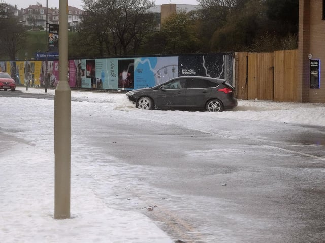 North Bay is coated in thick sea foam and spray as the storm hits.