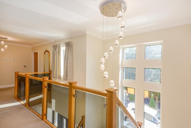 A feature window and gallery with glass balustrade, within the property.