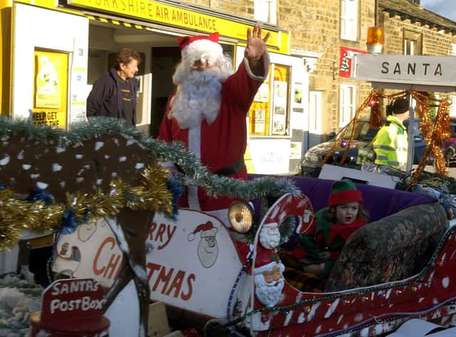 Father Christmas is pulled round the Market Place at Masham Victorian Fair.