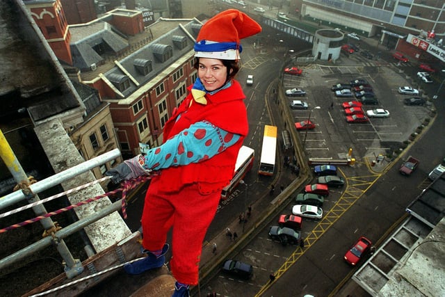 Fleur Robinson is pictured in a pixie outfit at the start of her abseil from the roof of the Queens Hotel in City Square to raise money for charity.