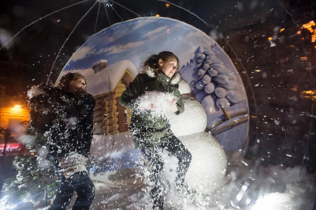 Revellers visit the snow globe at the Dewsbury Christmas lights switch-on in 2015