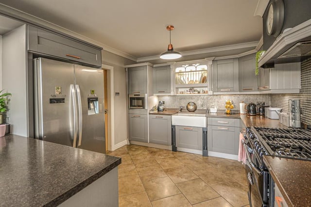 The kitchen, with under floor heating, includes a range cooker and many appliances.