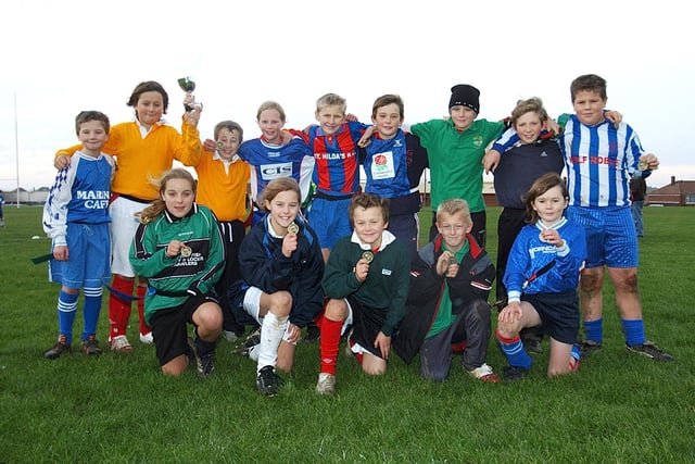 Whitby youngsters show off their medals for taking part in an inter-school rugby workshop.