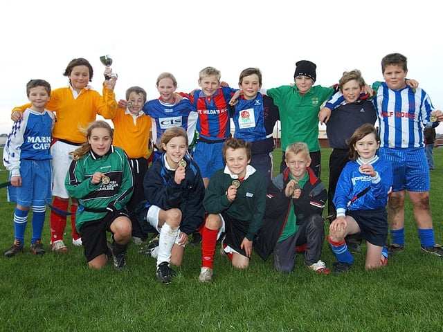 Whitby youngsters show off their medals for taking part in an inter-school rugby workshop.