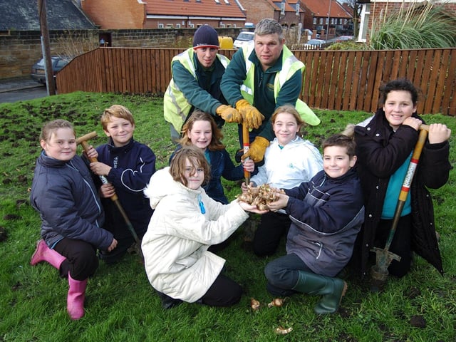 Pupils from East Whitby School plant daffodil bulbs on The Ropery as part of Deep Clean Day.