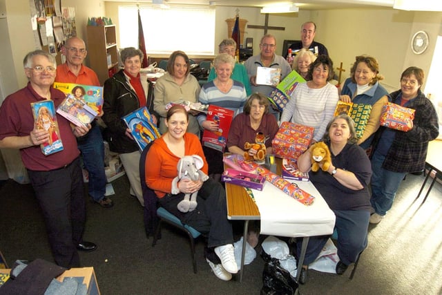 Whitby Salvation Army and Inner Wheel volunteers wrap presents for families in need.