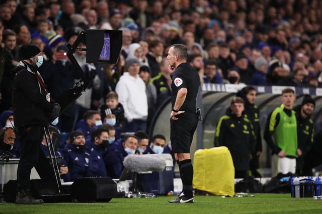 Referee Kevin Friend consults his pitchside monitor.
