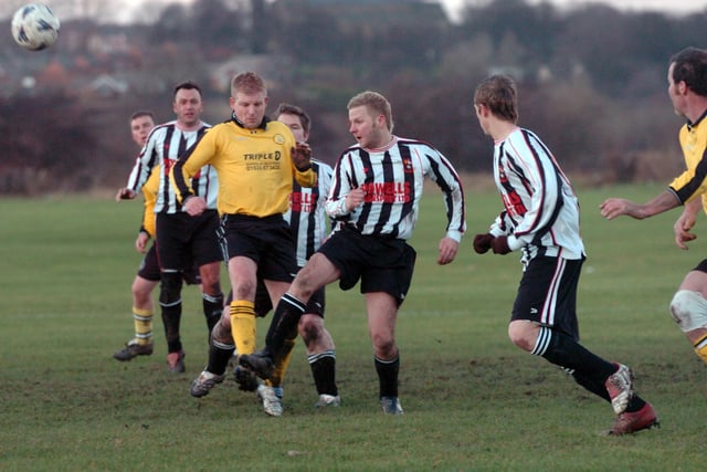 Stanley United v Nostell MW. Wakefield and District League. Daz Whitaker, centre,  of Stanley United clears.