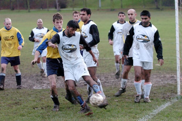 Wakefield United v Exel. Wakefield and District League Division 3. Saqlain Hussain of Wakefield United clears his lines under pressure from Lee Smith of Exel.