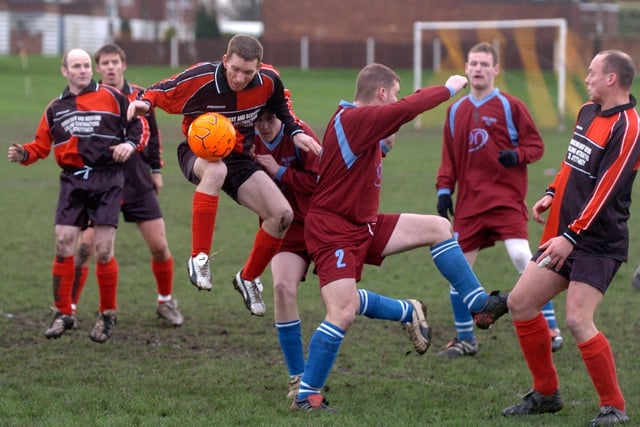 East Ardsley Generals v Ryhill. Wakefield and District League. Mick Daines of East Ardsley Generals clears the ball under pressure from Alistair Burnage.