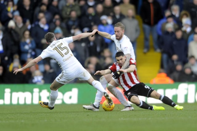 Pontus Jansson and Stuart Dallas stop Brentford striker Neal Maupay in his tracks.