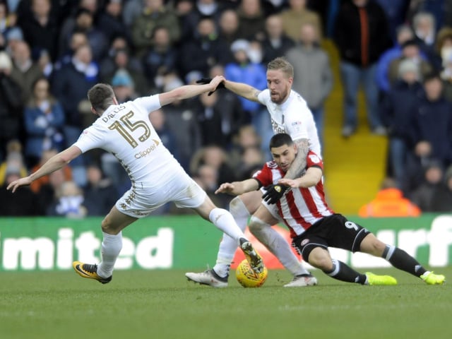 Pontus Jansson and Stuart Dallas stop Brentford striker Neal Maupay in his tracks.