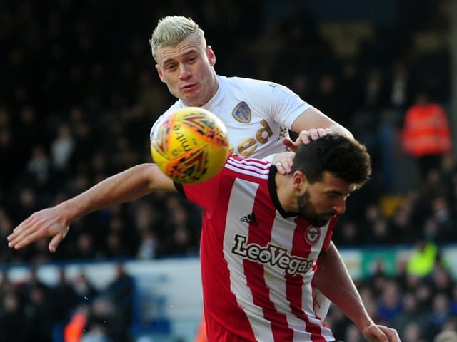 Ezgjan Alioski is challenged by Brentford's Yoann Barbet.