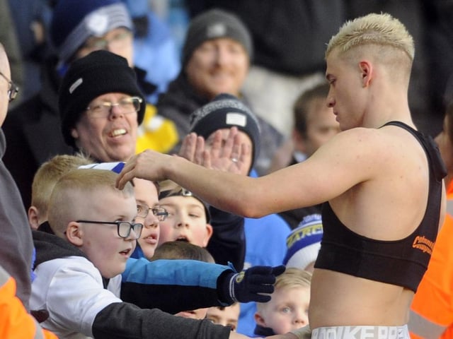 Ezgjan Alioski gives his shirt to a young fan.