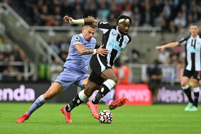 Phillips battles Allan Saint-Maximin during the Whites' 1-1 draw with Newcastle United at St James' Park in September 2021.