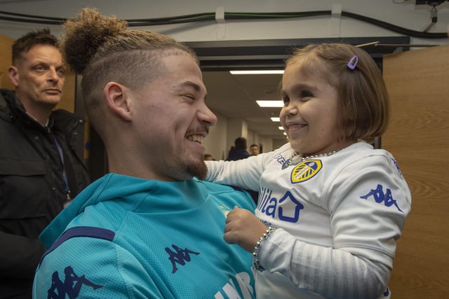 Phillips with young fan Sarah Emmott, who joined Leeds' number 23 on the pitch as mascot ahead of the Whites' 1-1 draw with Preston North End on Boxing Day 2019.