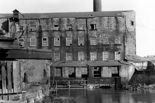 Nether Mills from the River Aire pictured in March 1954. The building is derelict, and has a large chimney behind.