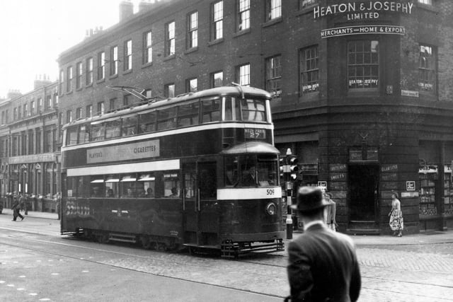 September 1954 and tram no 509 is pictured travelling along Cookridge Street towards the junction with Great George Street on route 27 to Hyde Park. I Harris Grocers can be seen on the corner of Cookridge Street. Y W C Club and Cafe can also be seen.