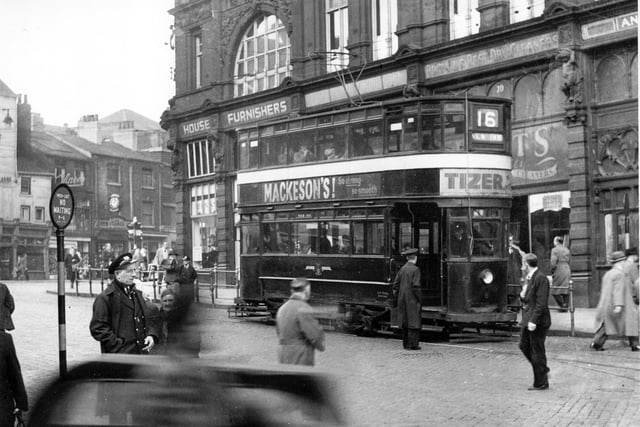 Tram No 6 on Route 16 to the New Inn in October 1954. The tram is on Kirkgate at the side of Kirkgate Market and the camera is looking in the direction of Vicar Lane. Adverts for Mackeson's Stout and Tizer can be seen on the side and front of the tram.