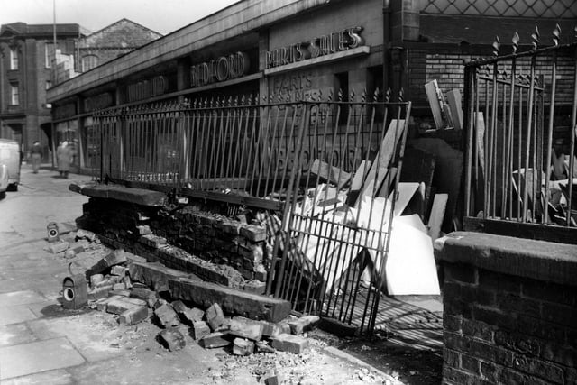 Damage to wall of  premises of Leeds Marble and Heating Works on Woodhouse Lane in March 1954.